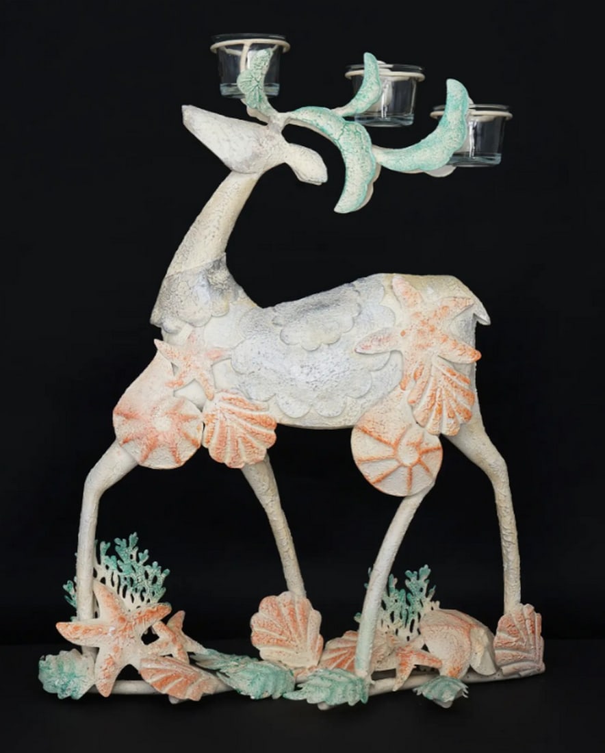 21" Iron Seashells Reindeer with Candle Holders: 21" Iron Seashells Reindeer with Candle Holders Handcrafted from iron and glass, this decorative showpiece depicts a reindeer accented with seashell motifs. Designed with integrated candle holders
