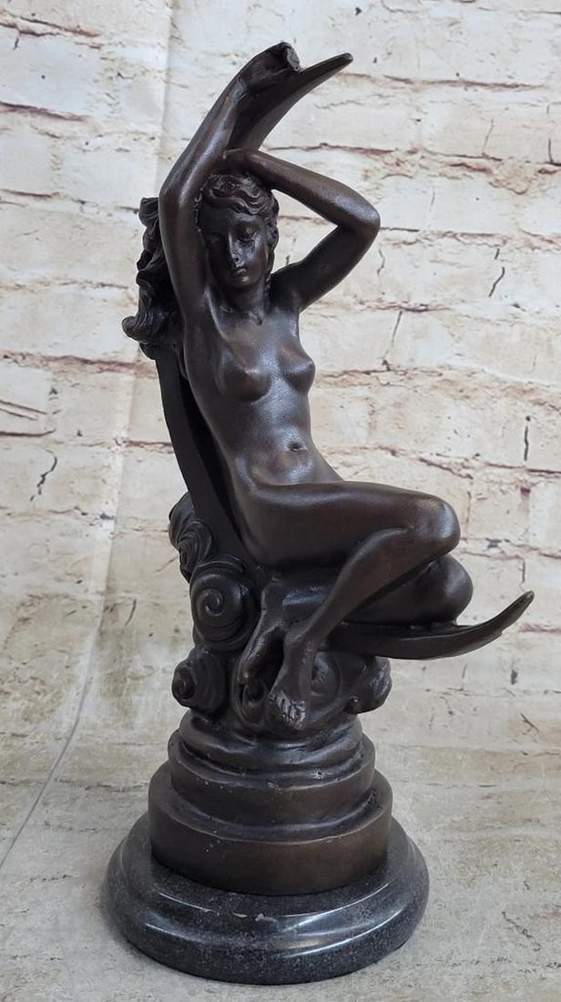 Roche Inspired Nude Sensual Female On Moon Bronze Sculpture - 11" x 7": Roche Inspired Nude Sensual Female On Moon Bronze Sculpture - 11" x 7" The bronze sensual woman sits upward, extending her arms in the air with her legs crossed. Her arms wrap around her head