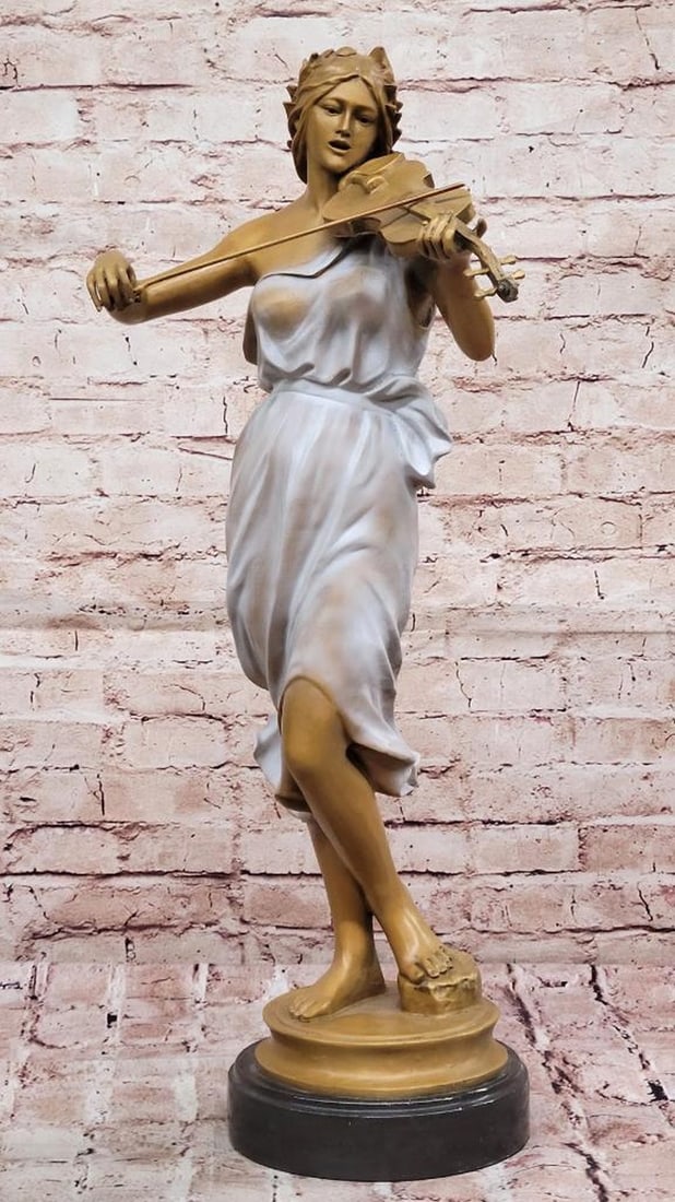The Violinist’s Muse Bronze: The Violinist’s Muse Bronze The Violinist’s Muse is a stunning bronze-copper sculpture that captures the poise and passion of a woman immersed in her music. With her violin delicately cradled, sh