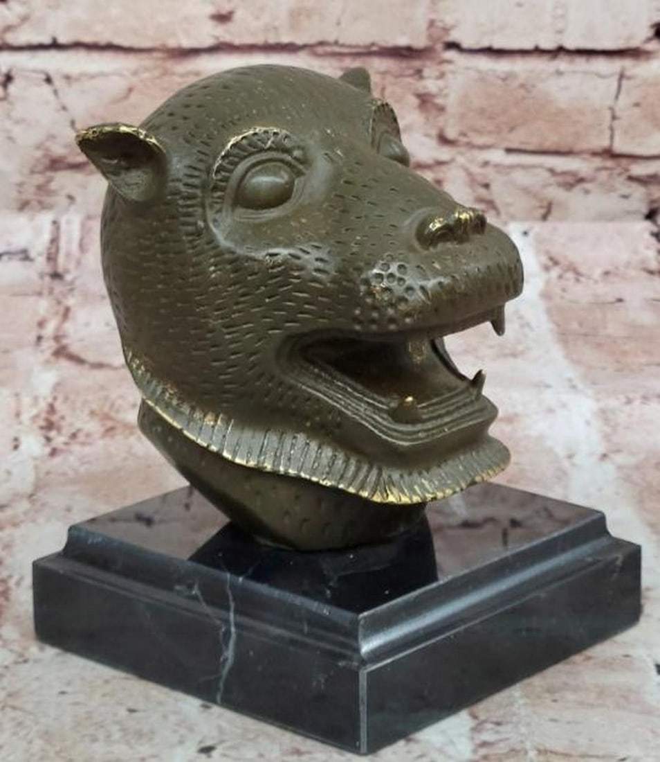 Fierce Majesty: Bronze Tiger Head Bust: Fierce Majesty: Bronze Tiger Head Bust Commanding and intense, this bronze bust sculpture captures the raw power and regal presence of the tiger. The finely sculpted head features piercing eyes, a po