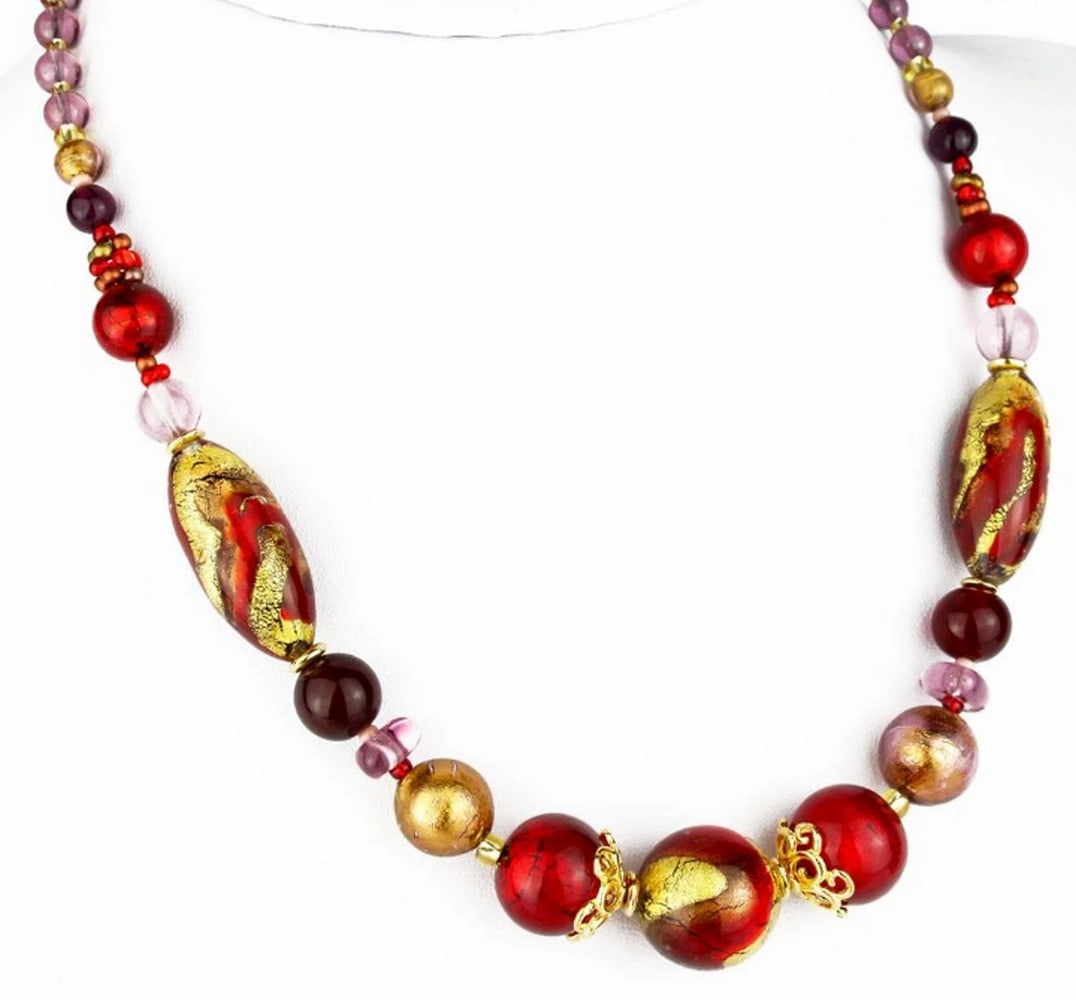 Aurelia Gold Toned Glass Beaded Necklace: Aurelia Gold Toned Glass Beaded Necklace This necklace is made in lamp working technique, and each bead is worked as single piece. Beads are made in molten glass, so this necklace is a perfect jewels