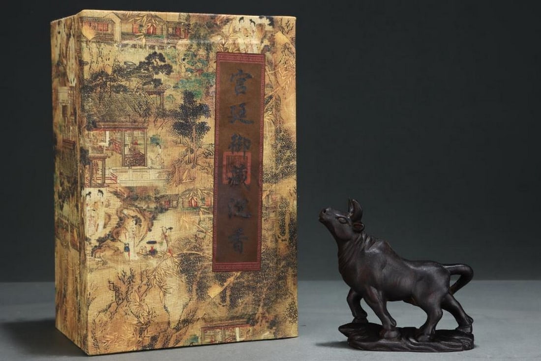 Inspired Old Palace Collection Agarwood Cow Ornament: Inspired Old Palace Collection Agarwood Cow Ornament A charming agarwood cow ornament, expertly carved to capture the gentle form and spirit of the animal. The rich aroma and natural grain of the age