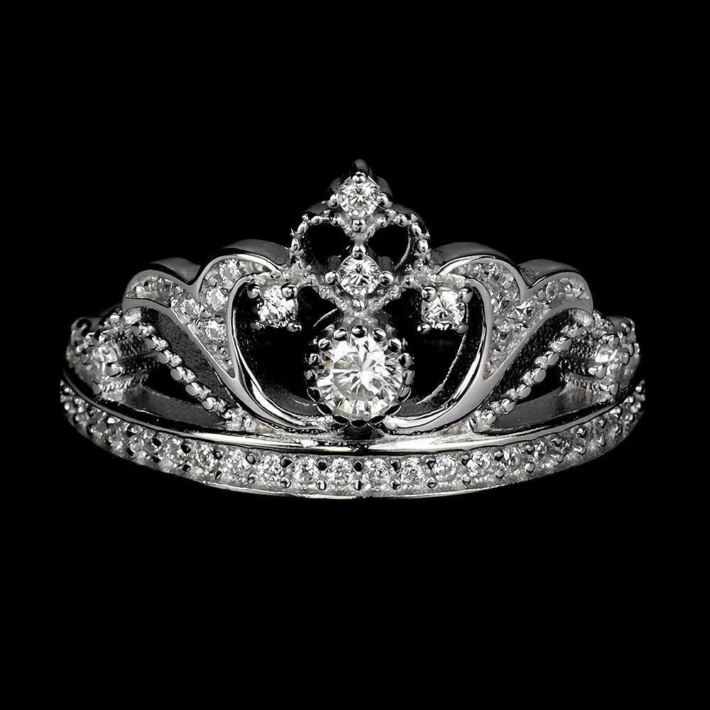 Sterling Silver Crown Ring with Round CZ - Size 7: Sterling Silver Crown Ring with Round CZ - Size 7 This sterling silver ring showcases a regal crown design, accented by a stunning round cubic zirconia centerpiece. A graceful and refined piece, perfe