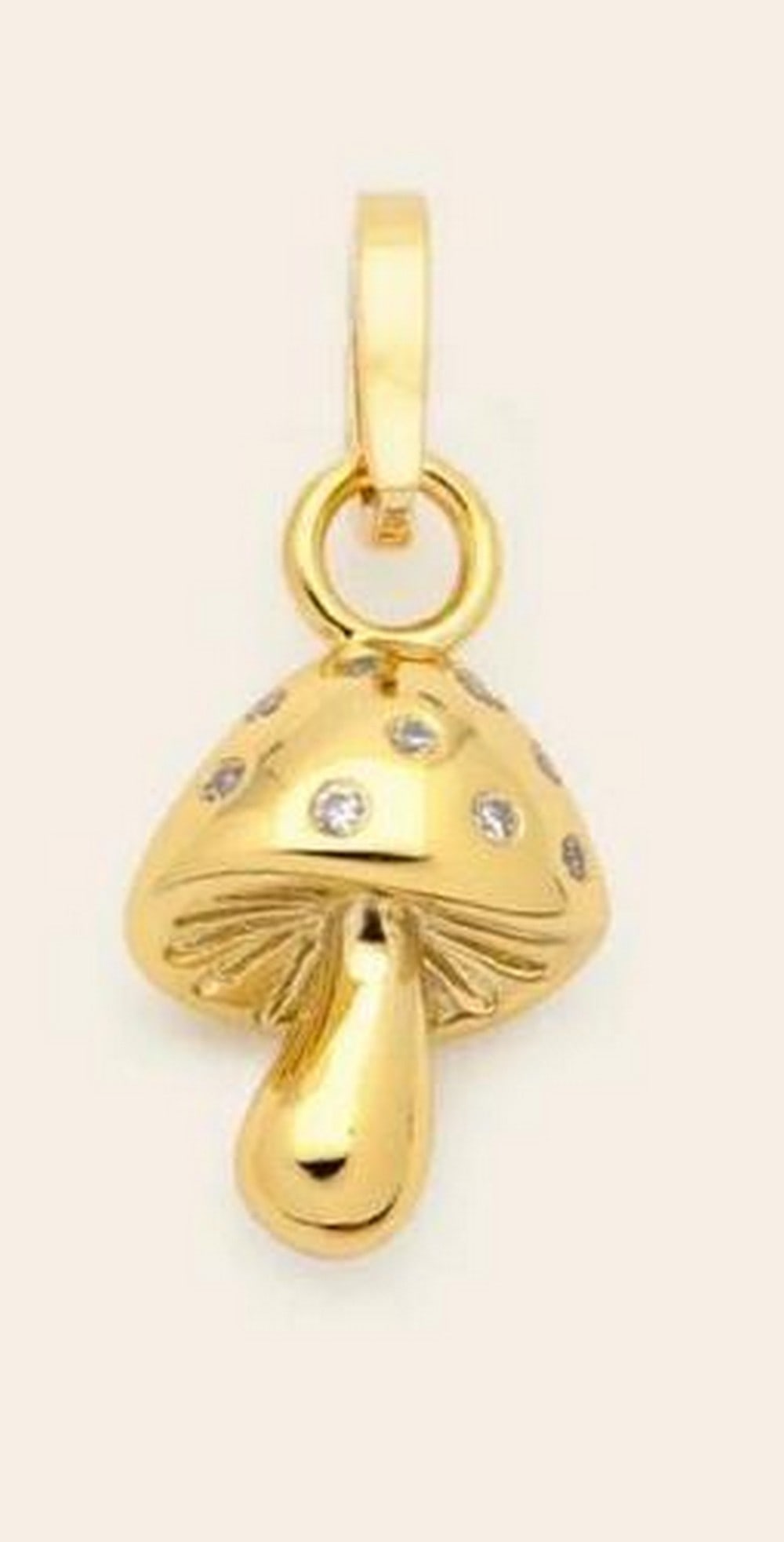 Golden Mushroom Charm: Golden Mushroom Charm A whimsical mushroom-shaped charm with a sculptural silhouette and subtle sparkle. The design blends playful character with refined detailing, creating a piece that feels