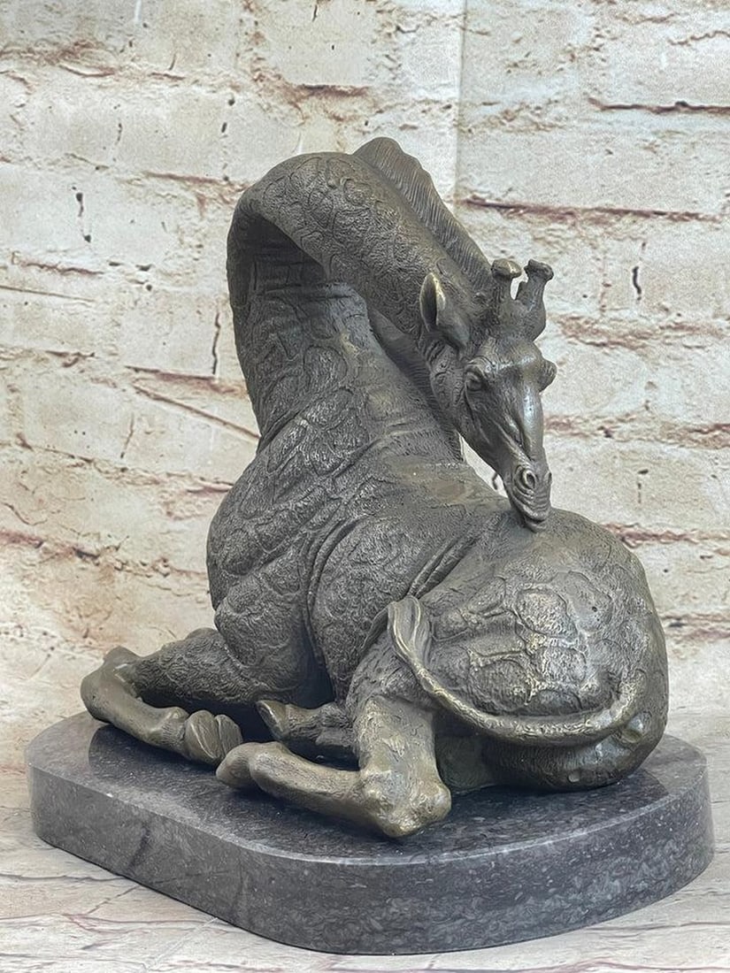 Graceful Giraffe Bronze Statue: Graceful Giraffe Bronze Statue Giraffe`S Can Be Both Graceful And Clumsy. The Unique Animal Known For Its Spots And Long Neck, Lays Down For A Moment Of Rest.She Bends Her Long Neck Over Her Back