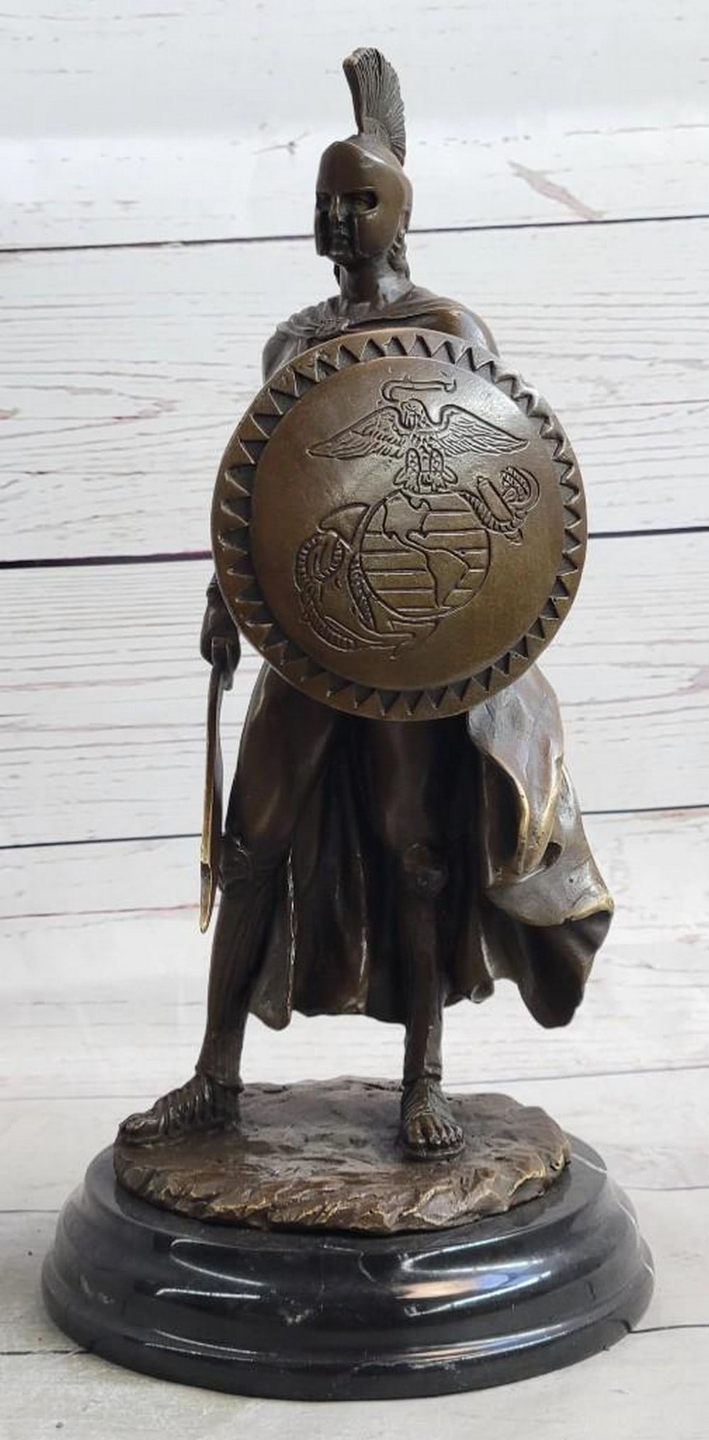 Roman Spartan Warrior Bronze Sculpture: Roman Spartan Warrior Bronze Sculpture The Roman legion soldier stands nude, except for some regalia, looking to the horizon of a scarred battlefield. A top of his head he wears a galea, which is a s