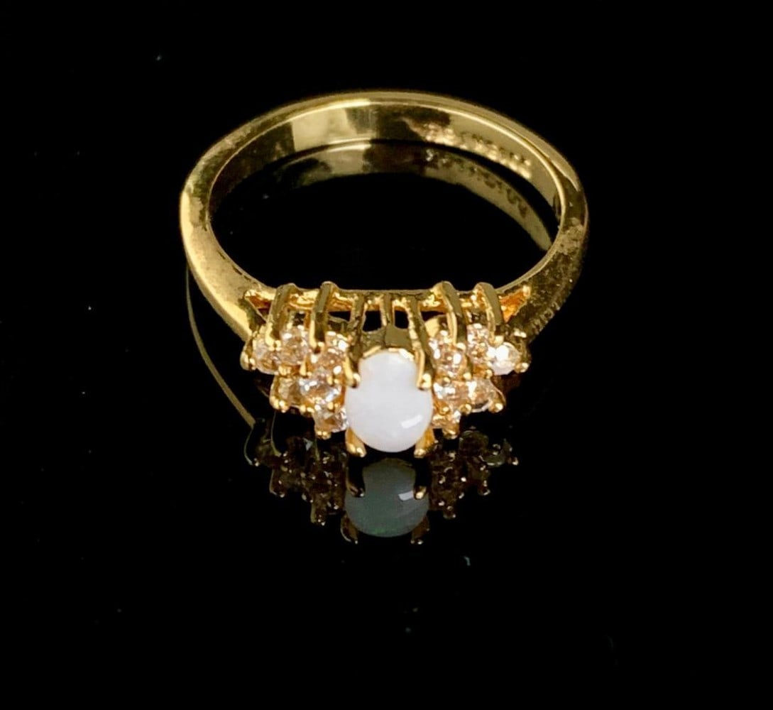 Size 8 .13ct Oval Cut Opal in 18K Gold Plated Ring: Size 8 .13ct Oval Cut Opal in 18K Gold Plated Ring. Please view photos for further details.