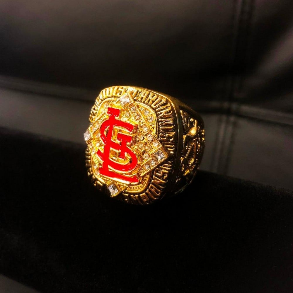 2006 St. Louis Cardinals - MLB Championship Ring: 2006 St. Louis Cardinals - MLB Championship Ring. In Enameled Red Stand Out Clearly On The Front This Gold Gilt Ring. A Great Addition For Any MLB Collection Or St. Louis Cardinals Fan The St. Louis