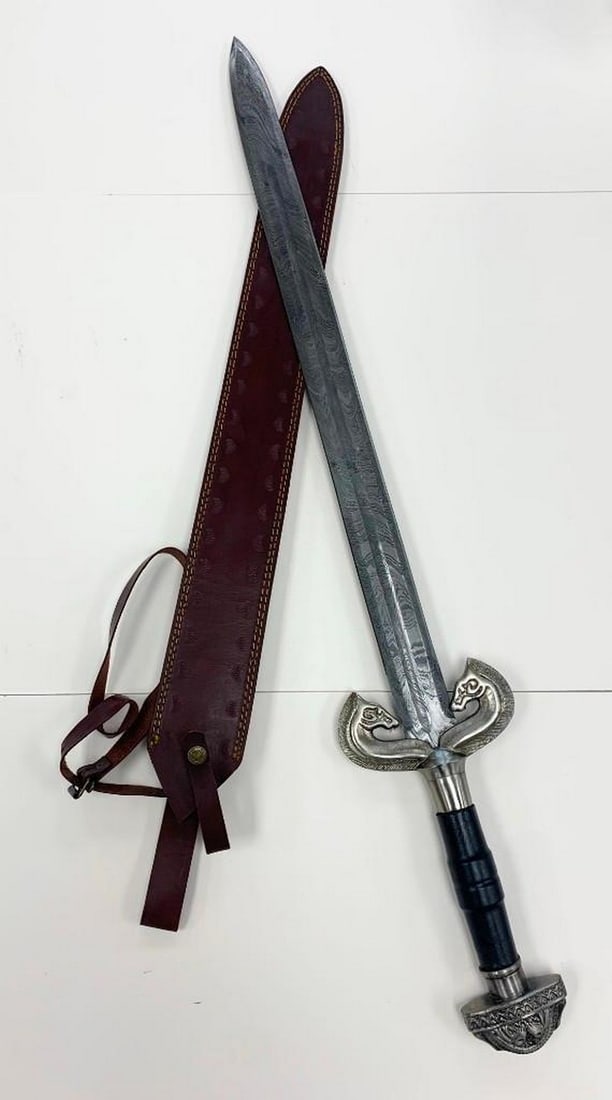 Stormrider Damascus Sword: Stormrider Damascus Sword. This finely crafted Damascus steel sword, is known for its distinctive, durable blade with intricate patterns. The blue handle offers a comfortable and secure grip,