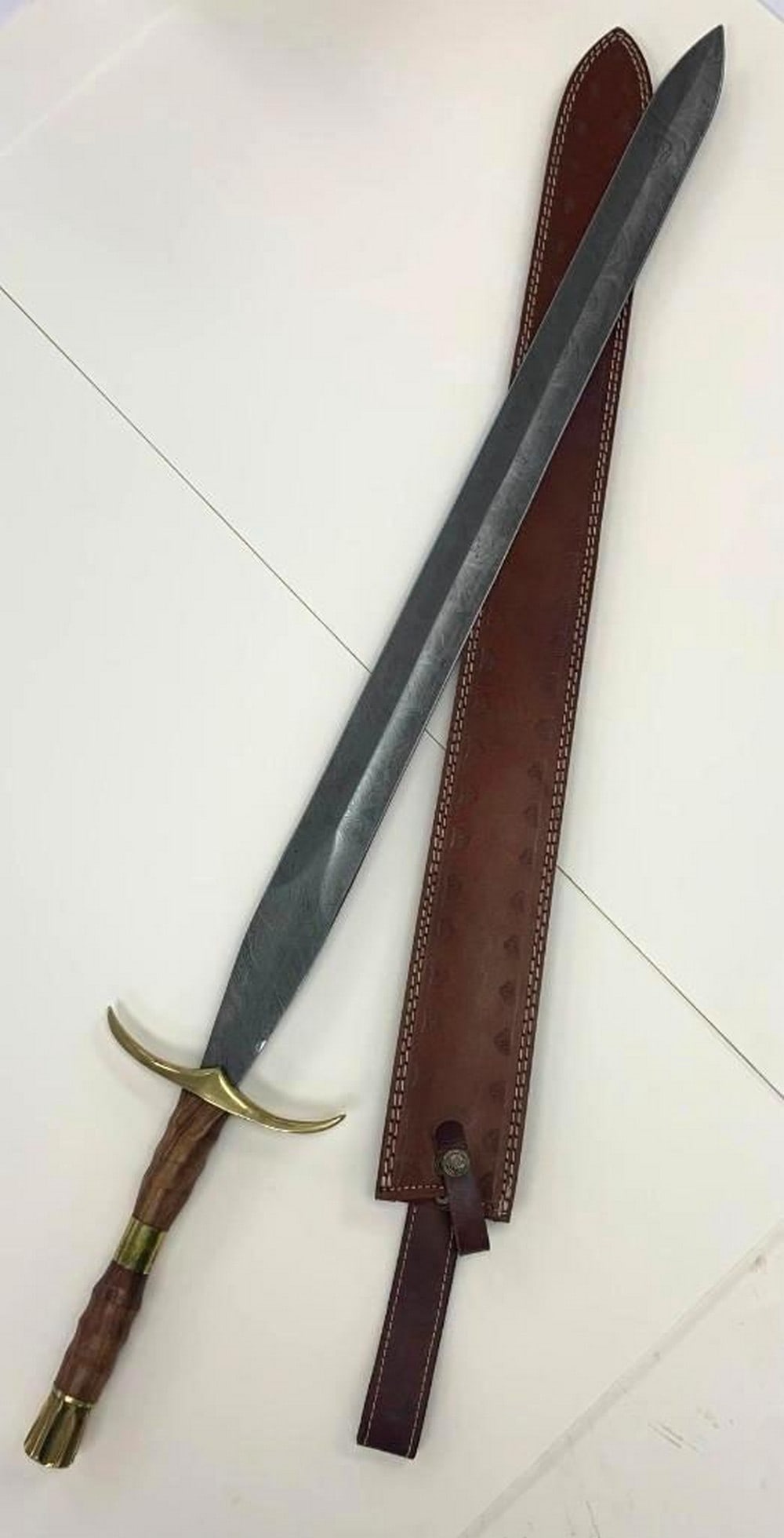Ashen Vortex Damascus Sword: Ashen Vortex Damascus Sword. This Sword Is A Masterfully Forged Damascus Blade, Known For Its Distinctive, Swirling Pattern. Its Sharp Edge Is Both Durable And Precise. The Wooden Handle, Smooth