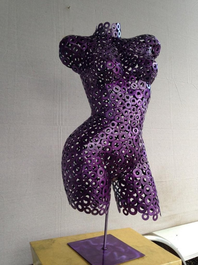 Passion Metal Sculpture: Passion Metal Sculpture A striking fusion of artistry and form, Passion is a life-size female torso sculpted and welded by hand. The polished textures catch the light, creating depth and movement,