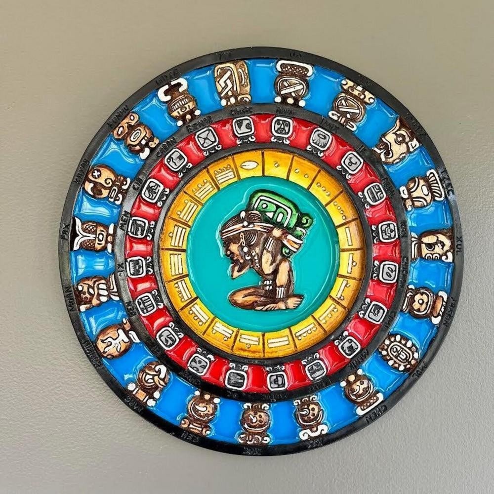 Hand Carved Multi-colour Aztec Calendar: Mayan-Aztec Calendar Wall Mask This handcrafted wall art beautifully merges Mayan and Aztec heritage, featuring an intricate 3D representation of the sacred calendar. Cast in lightweight resin with vi
