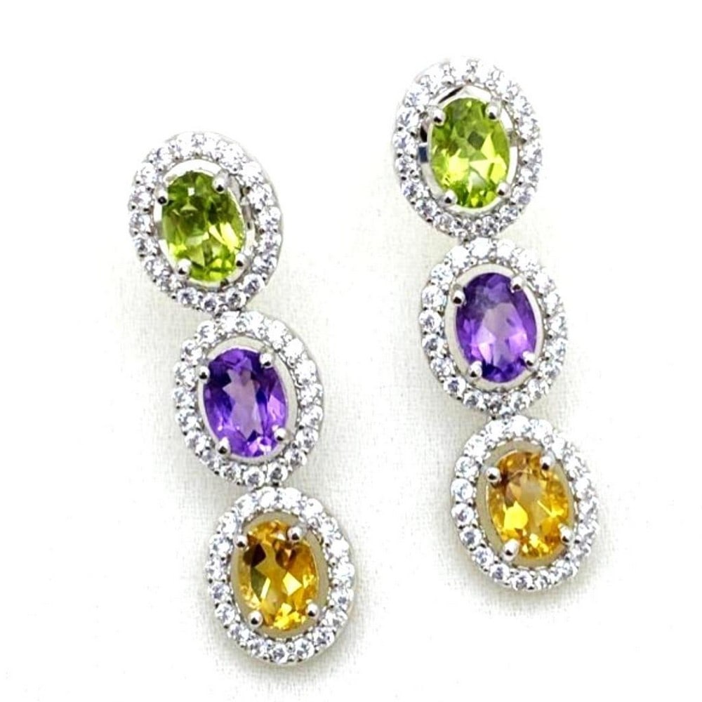 Zirconia Encircled Peridot, Amethyst, Citrine Stone Earrings: Zirconia Encircled Peridot, Amethyst, Citrine Stone Earrings These earrings are 925 Sterling Silver, each featuring one Peridot, Amethyst, and Citrine stone ringed with zirconias. View Photos