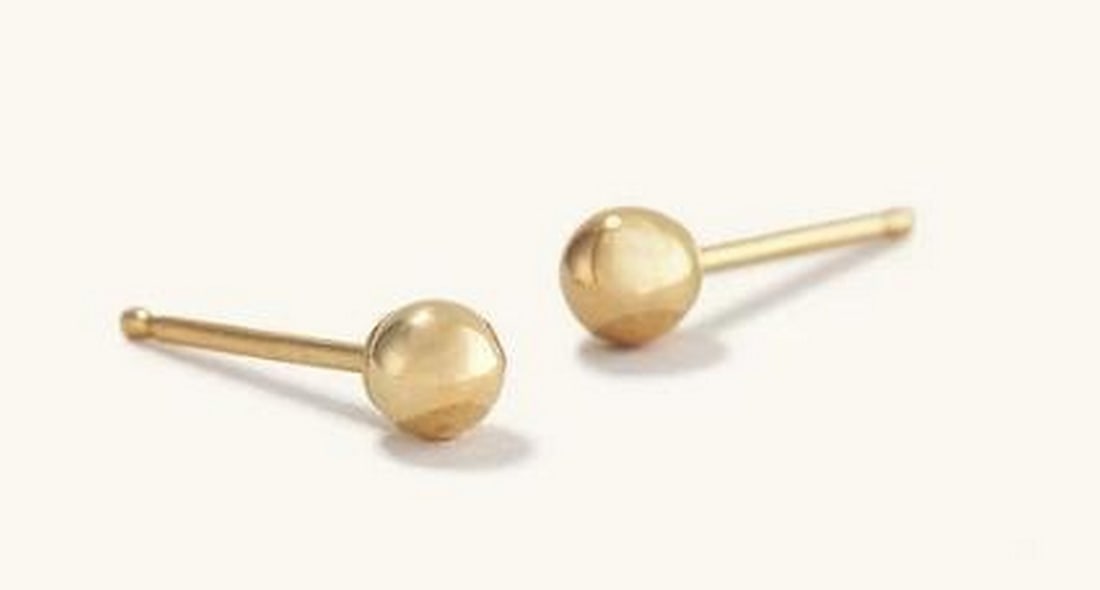 14K Yellow Gold Orb Studs: 14K Yellow Gold Orb Studs. Crafted from 14K yellow gold, these minimalist yet striking stud earrings feature smooth, round spheres that radiate a subtle, warm glow. Their sleek and sophisticated