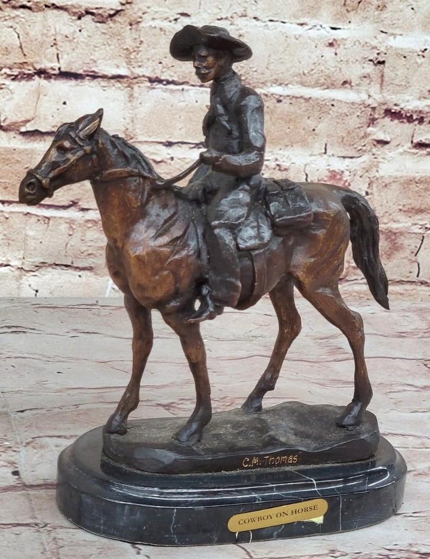 Will Rogers Wandering Cowboy Inspired Bronze Statue - 9" x 8": his art piece features a cowboy confidently riding his horse, crafted with meticulous attention to detail. The statue rests on a sleek black base, complete with a plaque bearing the name “C.M. Thoma