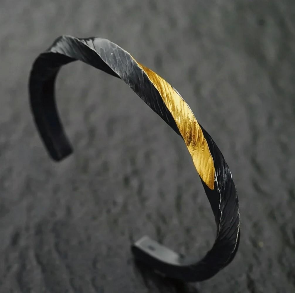 Flowing Fire Twist Bangle: Flowing Fire Twist Bangle Inspired by geometric elegance, the Flowing Fire Twist Bangle captures the essence of the Möbius form—a continuous, one-edged surface symbolizing infinity and fluidity.