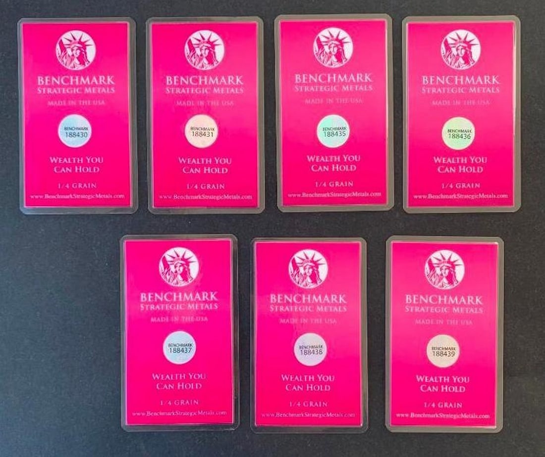 Lot of Seven Benchmark 1/4 Grain .999 Fine Gold Bars in COA Cards: Lot of Seven Benchmark 1/4 Grain .999 Fine Gold Bars in COA Cards This is a set of seven Benchmark Certificate of Authenticity cards, each containing an encapsulated 1/4 grain .999 fine gold bar.