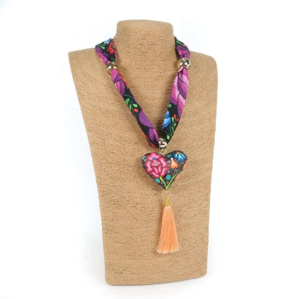 Oaxacan Alebrije Wood Carving Heart & Flowers Necklace: Oaxacan Alebrije Wood Carving Heart & Flowers Necklace Handcrafted from locally sourced copal wood, this heart-shaped necklace features vibrant floral designs and traditional Zapotec patterns