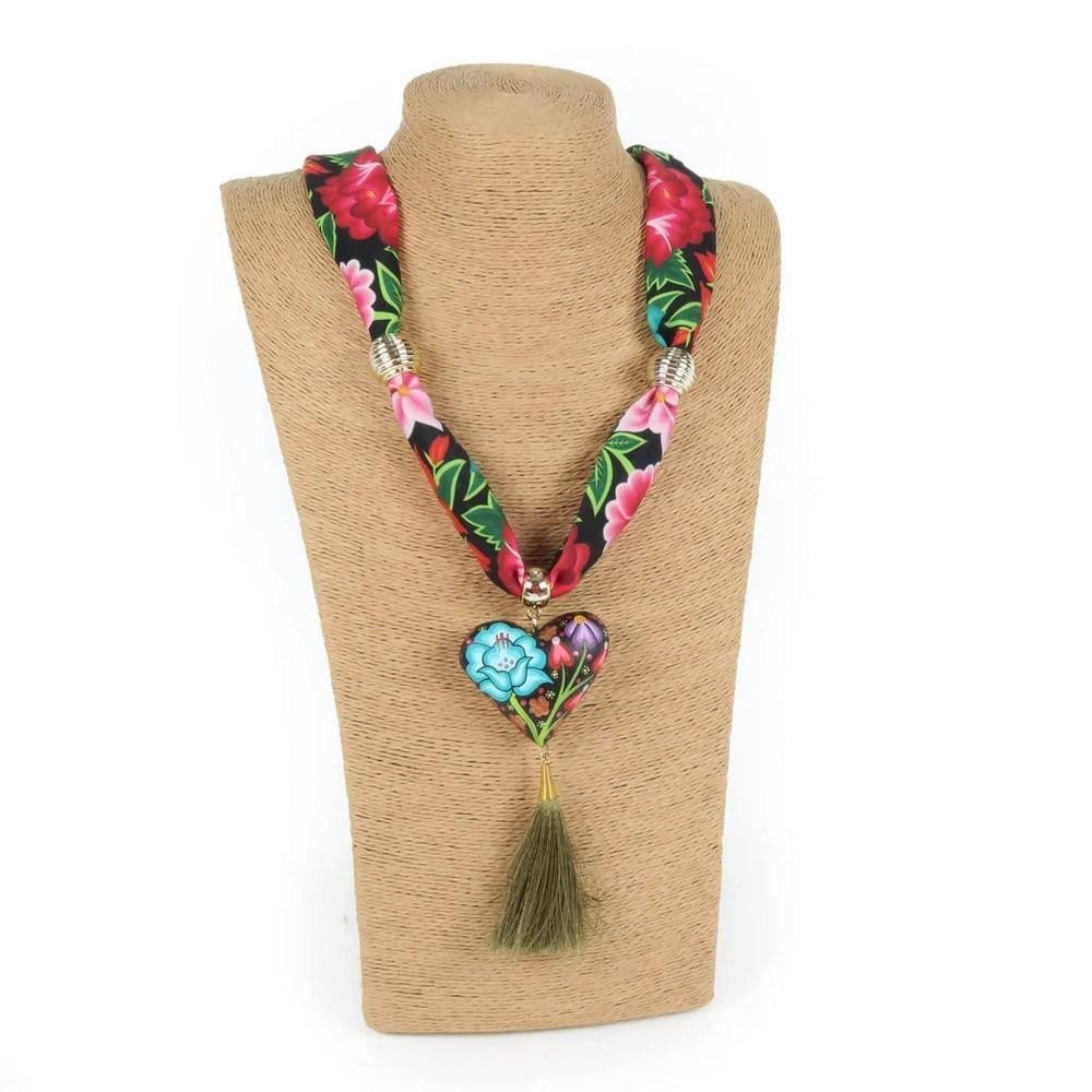 Oaxacan Alebrije Wood Carving Heart & Flowers Necklace: Oaxacan Alebrije Wood Carving Heart & Flowers Necklace Gorgeous heart necklace handcrafted from locally sourced copal wood, painted with colorful floral designs and traditional Zapotec patterns.