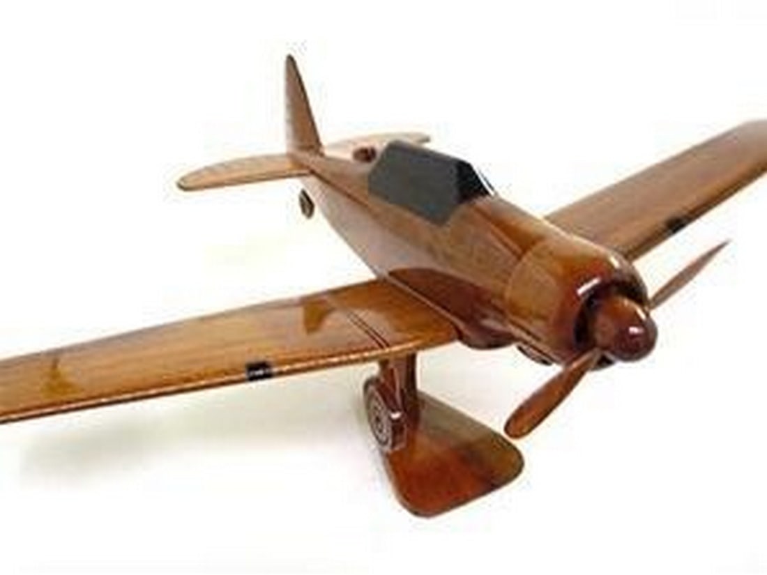 T-6 Texan Model Aircraft: T-6 TEXAN This meticulously crafted replica of the North American T-6 Texan showcases exceptional attention to detail, expertly carved from solid mahogany. The T-6 Texan, a single-engine advanced