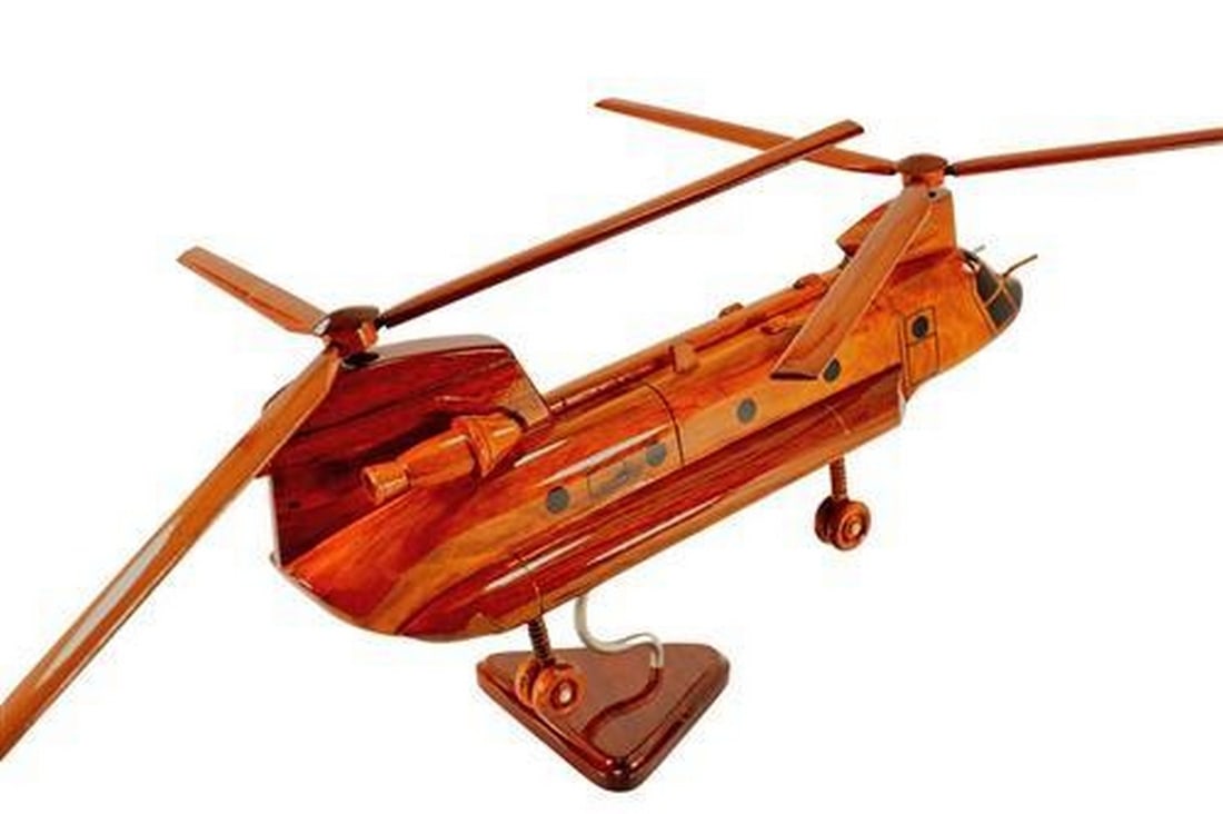 CH-47 Chinook Helicopter: CH-47 Chinook Helicopter This handcrafted scale model of the CH-47 Chinook Helicopter is made of solid mahogany. Exceptionally detailed, this replica includes movable rotors and wheels, and has three