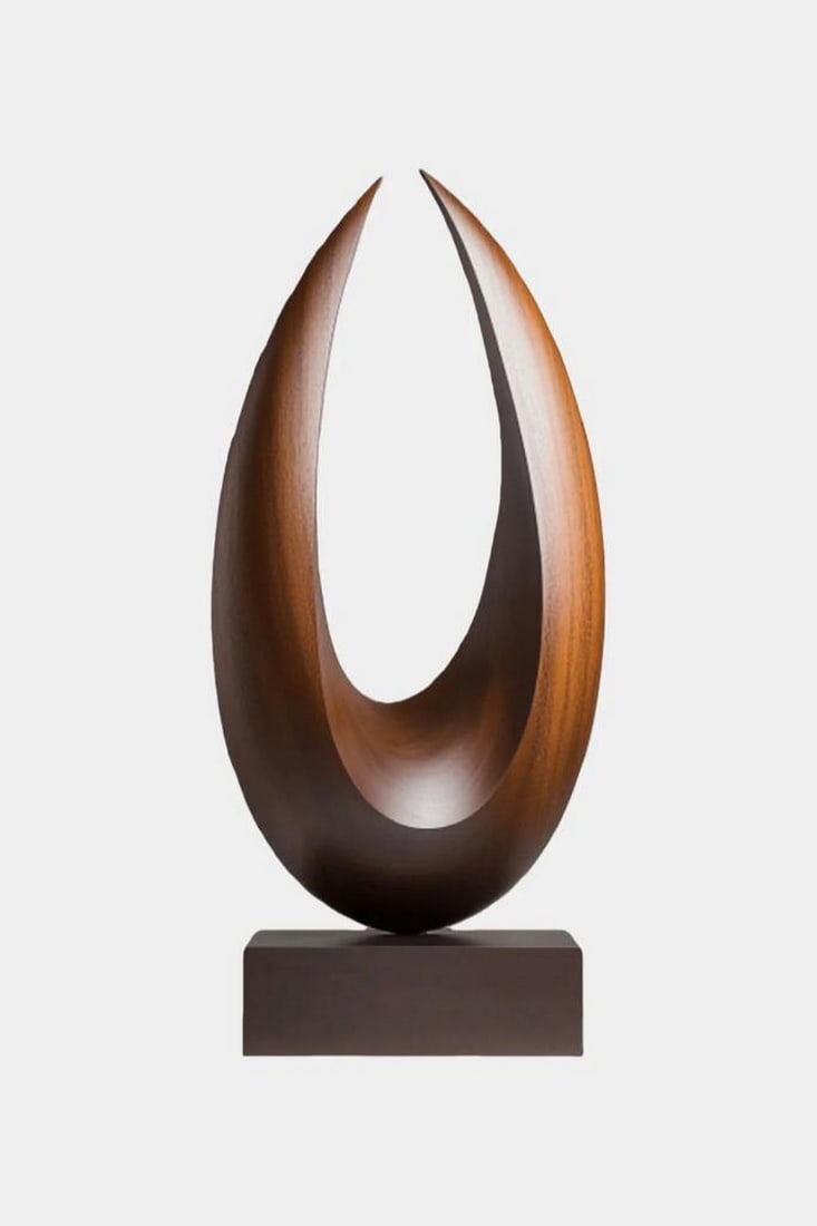 Teardrop Flame Wooden Sculpture: Teardrop Flame Wooden Sculpture A contemporary wooden sculpture shaped with a smooth, elongated teardrop silhouette and an open center that draws the eye upward. Its polished curves and warm wood