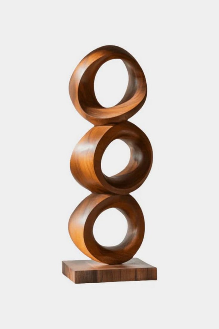 Trilogy in Timber – Contemporary Ring Sculpture: Trilogy in Timber – Contemporary Ring Sculpture This minimalist wooden sculpture features three perfectly circular rings, expertly carved and aligned atop a sleek rectangular base. Each ring