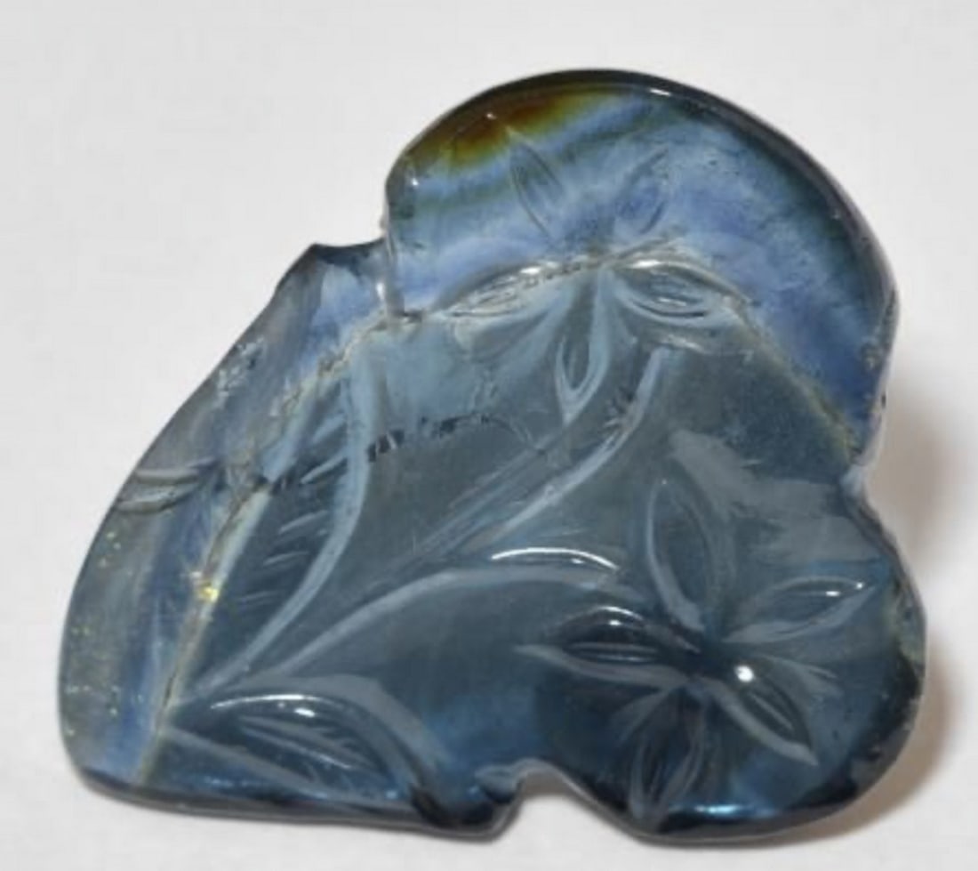 8.16ct Deep Blue Loose Tourmaline Untreated Gemstone: 8.16ct Deep Blue Loose Tourmaline Untreated Gemstone Weight: 8.16ct Size: 20mm L x 18.25mm W x 2.6mm D Shape: Carved Fruit Clarity: Transparent Treatment: Untreated Origin: Mozambique View Photo
