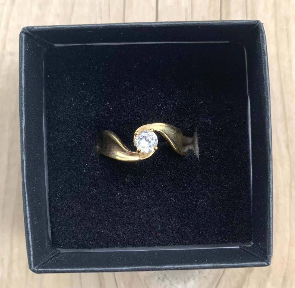 Sculpted Gold Moissanite Ring: Sculpted Gold Moissanite Ring A stunning marriage of artistry and fire, this sculpted gold ring features a gracefully flowing band that cradles a brilliant moissanite at its center. The warm