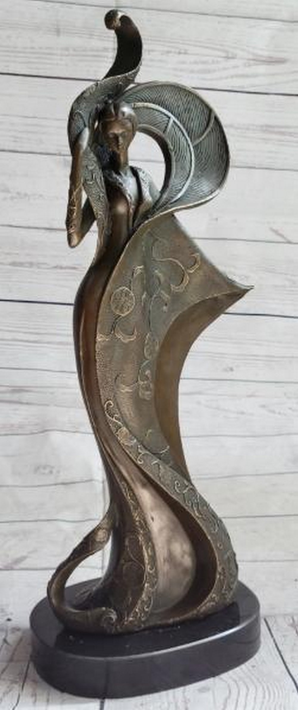 Elegance Ascending Bronze Sculpture: Elegance Ascending Bronze Sculpture This captivating bronze sculpture, bearing the signature of artist Kassin, portrays a woman draped in an abstract, flowing dress that rises dramatically around and