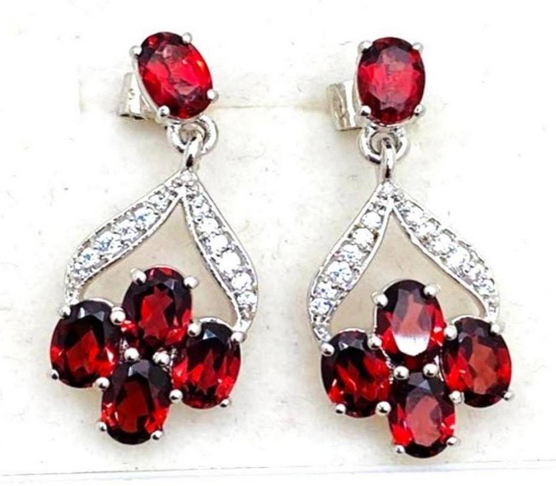 Red Garnet Stone Cluster Dangle Earrings: Red Garnet Stone Cluster Dangle Earrings These ravishing red garnet earrings are 925 Sterling Silver. They feature a cluster of 4 stones dangling from a stone on the front of the stud. View
