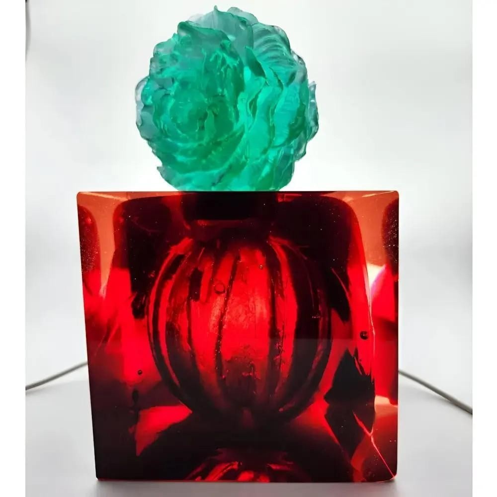 Red Glass Vessel with Peony Stopper by Sharon Korek: Red Glass Vessel with Peony Stopper by Sharon Korek This exquisite core-cast vessel by Sharon Korek is a stunning fusion of sharp cube form and the graceful Peony stopper, accented with a sterling sil