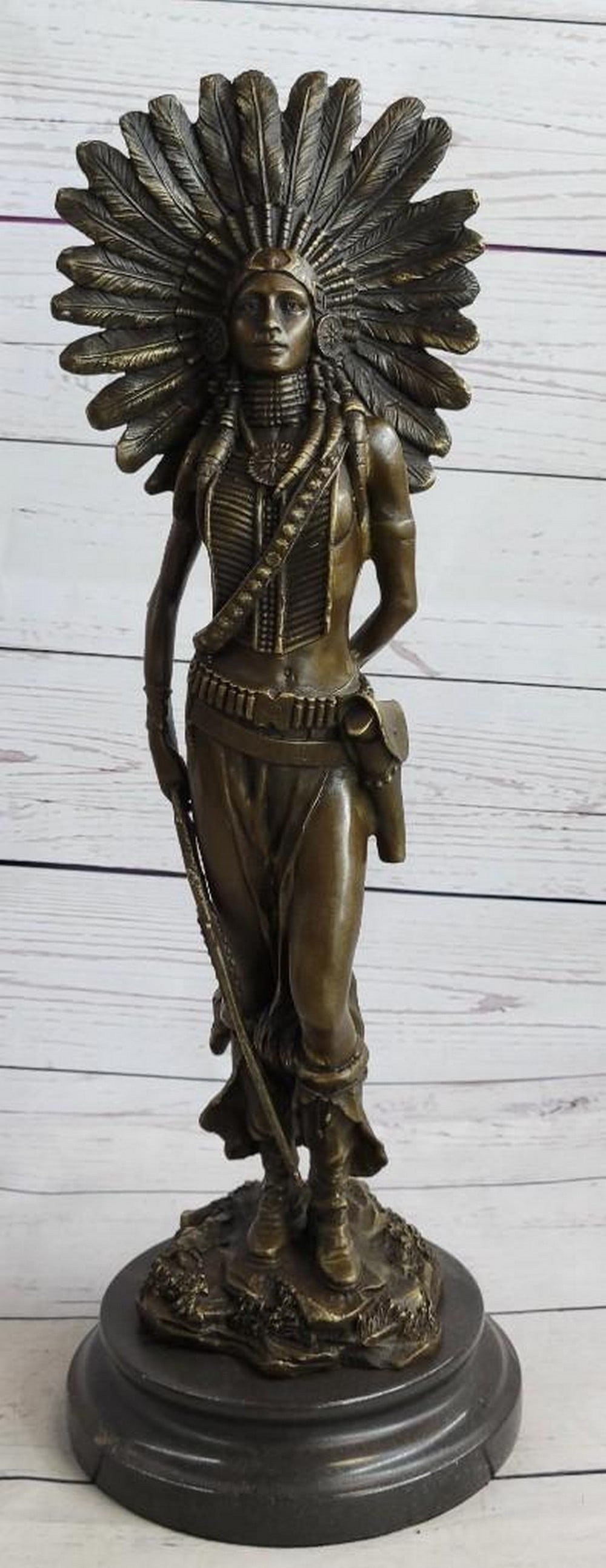 Native American Feathered Headdress Woman Bronze Sculpture: Native American Feathered Headdress Woman Bronze Sculpture A fierce Native American women prepares to hunt. She stands tall with bravery, silent confidence and stunning beauty on a grassy hill top. H