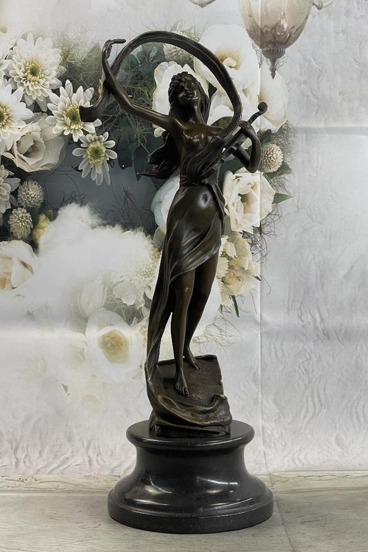 Female Violinist Player Musician Bronze Statue: Female Violinist Player Musician Bronze Statue A young woman finishes a powerful ballad on her violin. Her musical notes lift into the air that swirls around her, blowing her hair off her face. Her