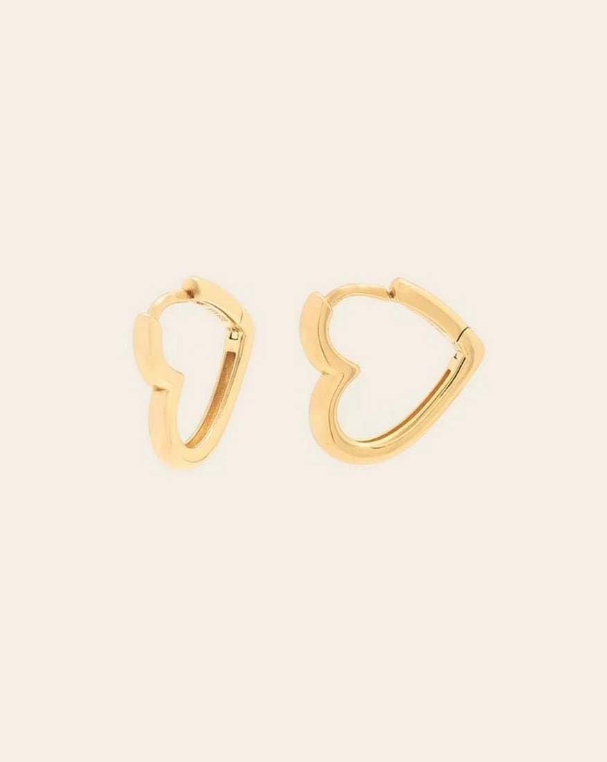 14k Vermeil Gold Plated Heart Huggie Earrings: 14k Vermeil Gold Plated Heart Huggie Earrings These 14k Vermeil Gold Plated Heart Huggie Earrings exude charm and elegance. Featuring delicate heart-shaped accents, they are crafted with a