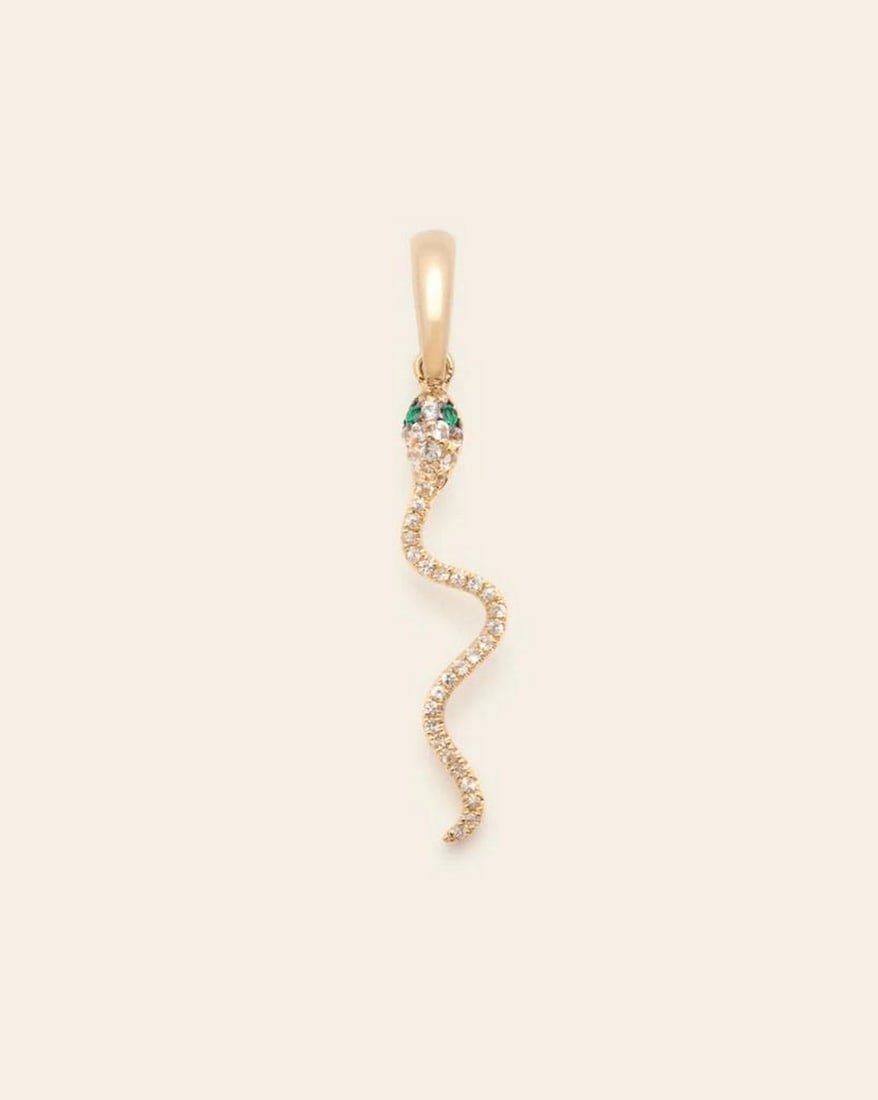 14k Solid Gold Pavé Serpent Pendant: 14k Solid Gold Pavé Serpent Pendant Adorned with 39 white sapphires and 2 emeralds, this pendant captures the transformative essence of the serpent, making a striking addition to any jewelry
