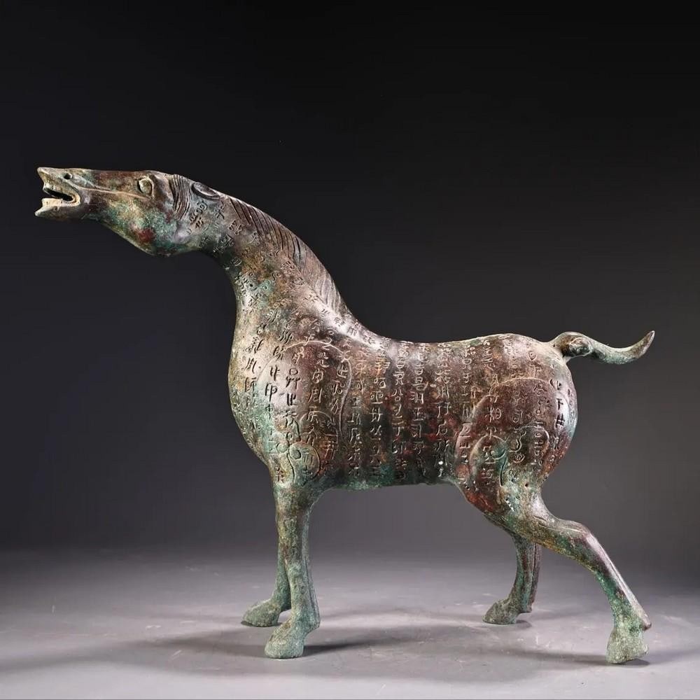 Antique Bronze Horse Statue: Antique Bronze Horse Statue This exquisite Chinese antique features a hand-crafted bronze horse, showcasing detailed artistry and a dynamic head-raising pose. Representing strength, vitality, and eleg