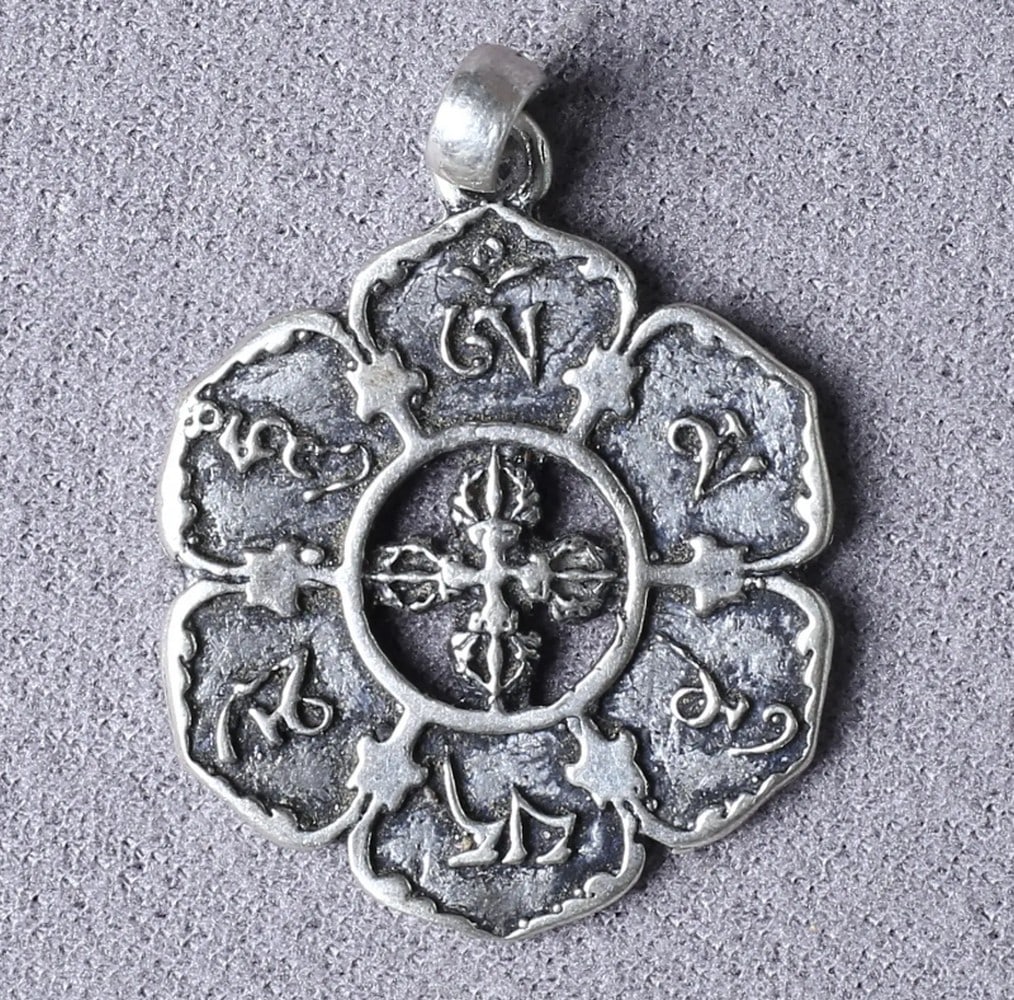 Eternal Strength Ohm Pendant: Eternal Strength Ohm Pendant The Ohm Viswa Vajra Silver Pendant embodies spirituality and fine craftsmanship. Featuring the sacred mantra "Ohm Mane Padme Hum" within lotus petals symbolizing