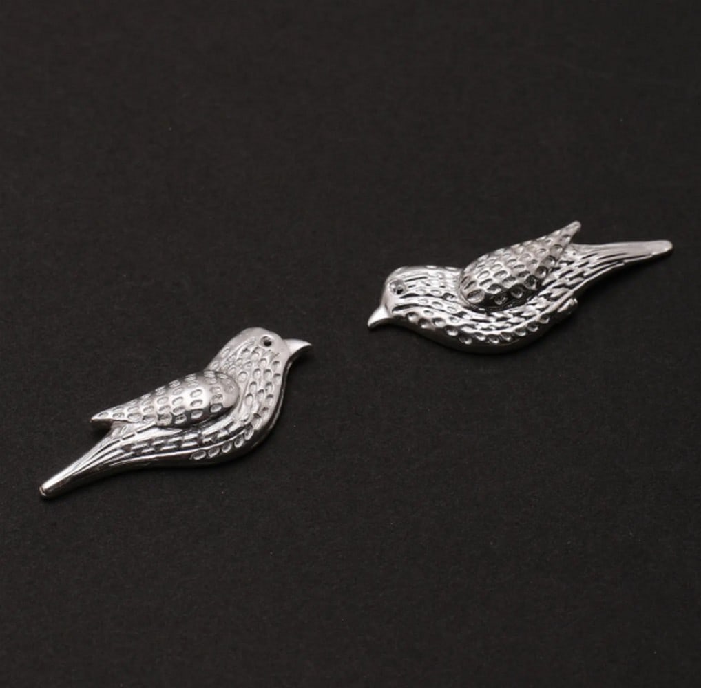 Soaring Silver Bird Studs: Soaring Silver Bird Studs These sterling silver bird stud earrings feature intricate detailing and a polished finish that reflects light beautifully. The textured design adds depth, creating a