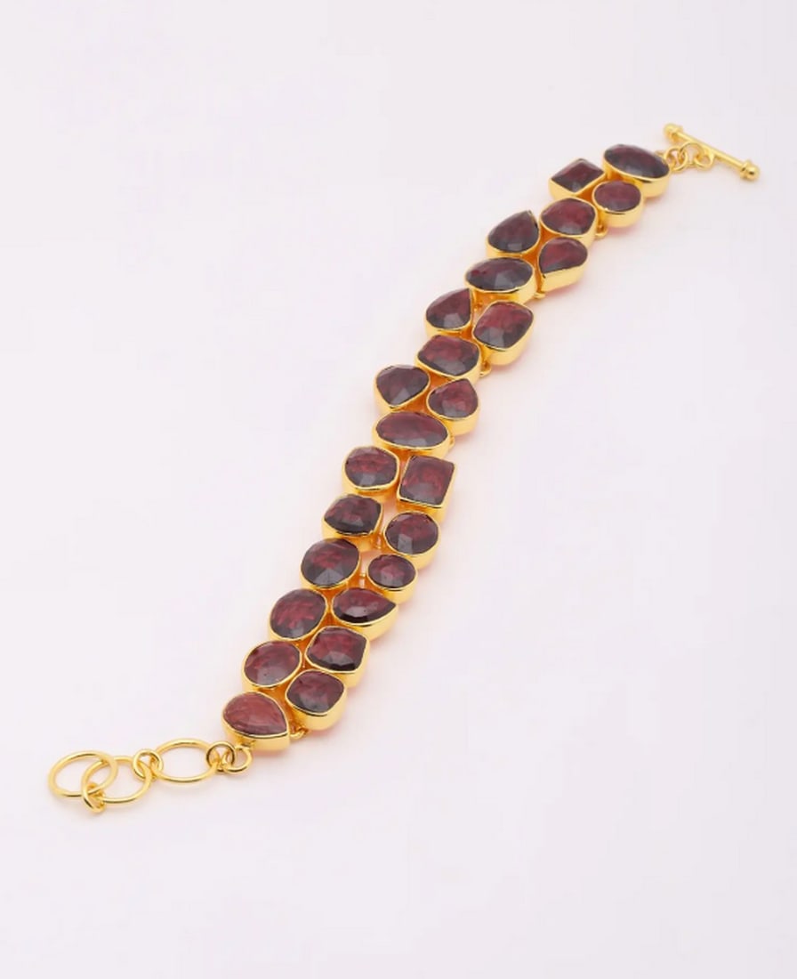 Hyderabadi Radiance Gemstone Bracelet: Hyderabadi Radiance Gemstone Bracelet Celebrate the artistry of Hyderabadi jewelry with this exquisite bracelet, crafted from gold-plated sterling silver and adorned with meticulously faceted garnet