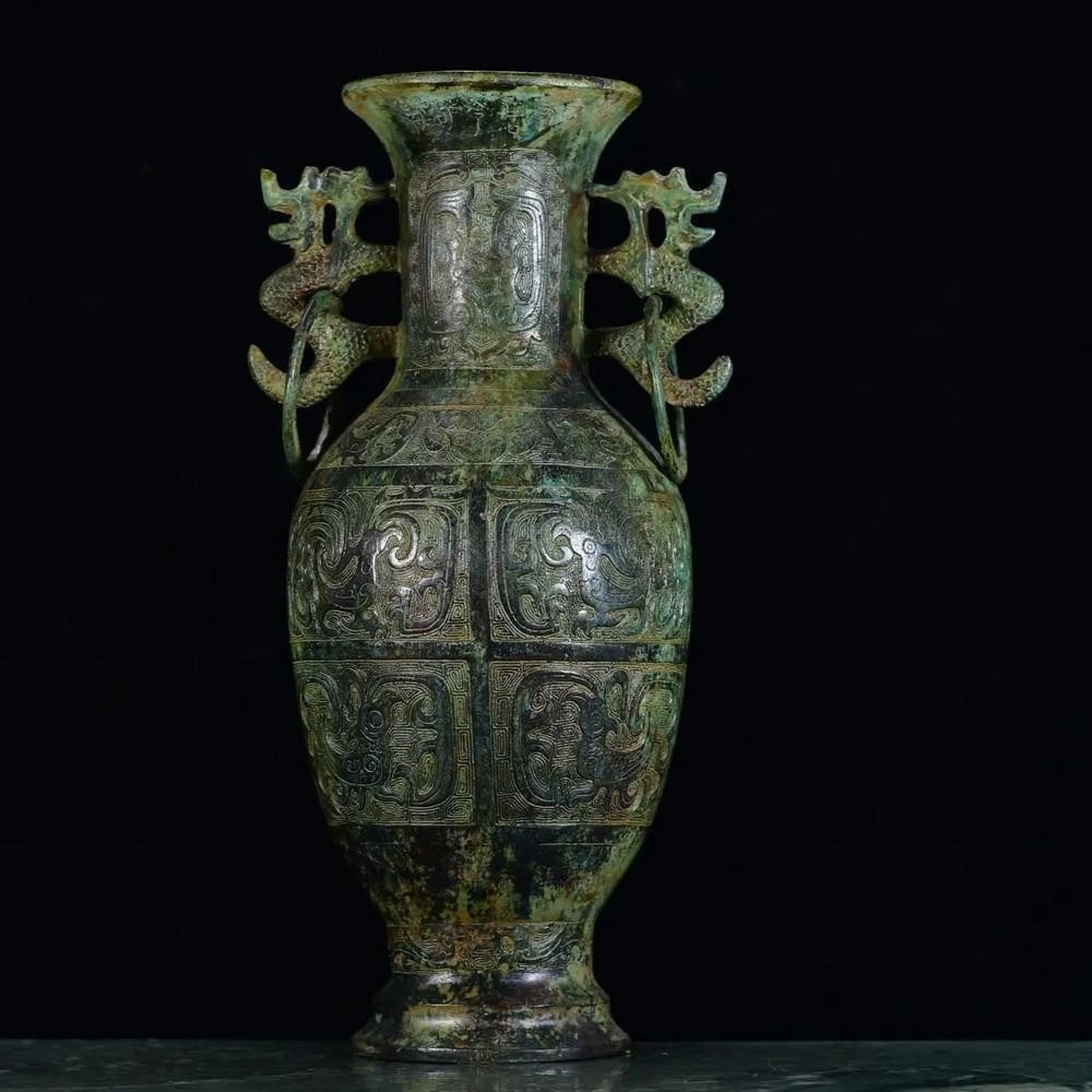 Antique Bronze Double Dragon Bottle with Animal Face Pattern: Antique Bronze Double Dragon Bottle with Animal Face Pattern This rare Chinese antique features a hand-crafted bronze bottle, adorned with an intricate animal face pattern and two powerful