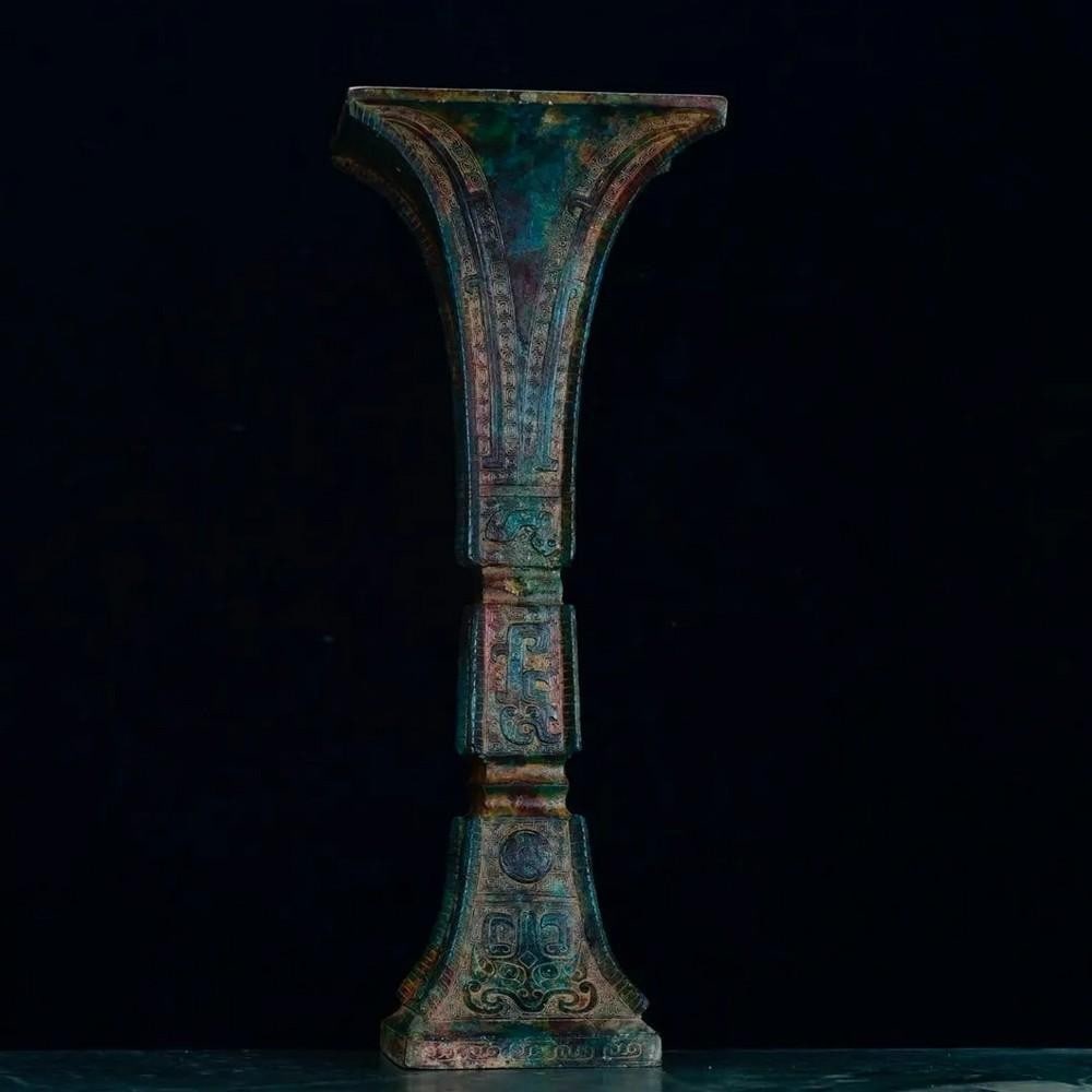 Antique Bronze Flower Vase Goblet Statue: Antique Bronze Flower Vase Goblet Statue This exquisite Chinese antique showcases a hand-made bronze goblet, adorned with detailed floral motifs. Representing beauty and vitality, the finely crafted