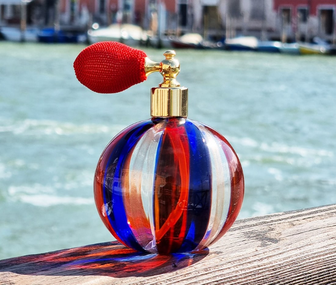 Murano Glass Perfume Atomizer: Murano Glass Perfume Atomizer This small blue bottle is handmade using the blown glass technique, adorned with aventurine and color canes in blue, red, and white. The perfume scent bottle is crafted