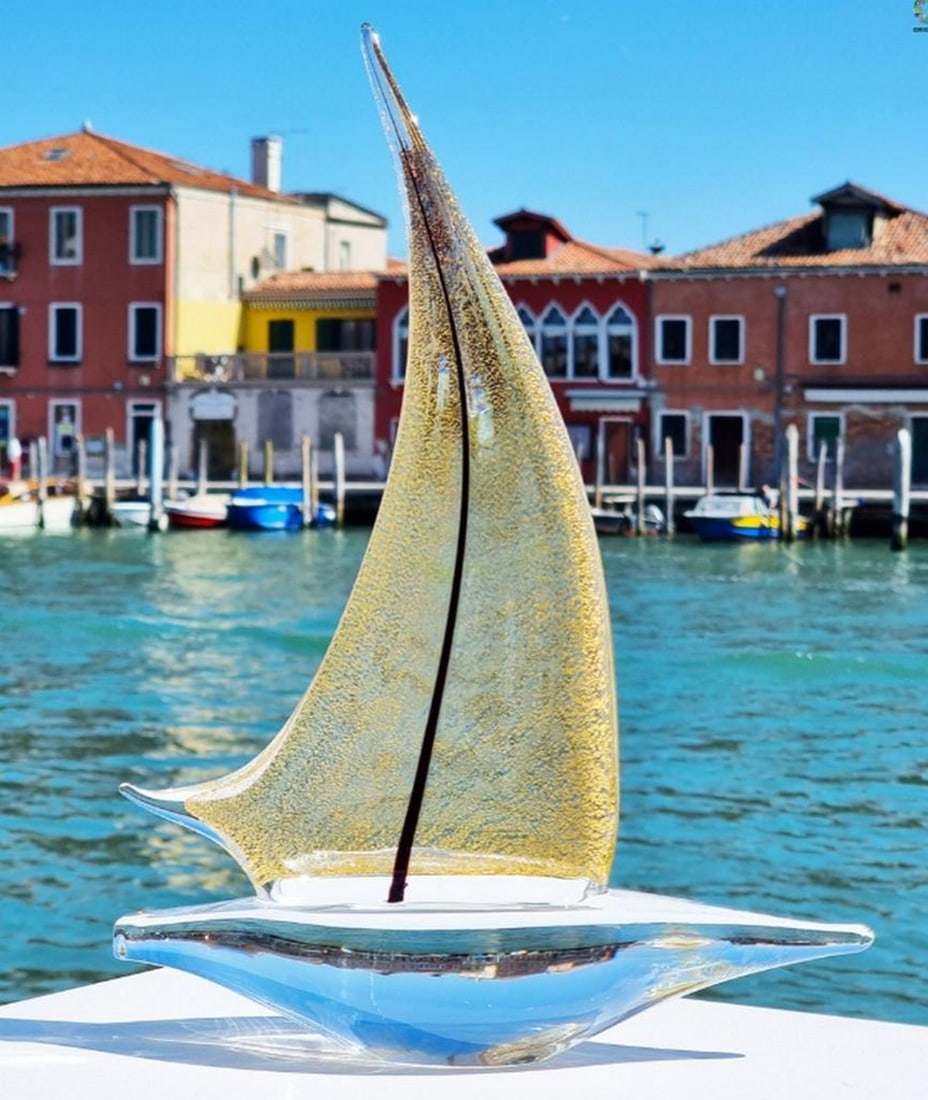 Murano Glass Sailing Vessel – 24 kt Gold: Murano Glass Sailing Vessel – 24 kt Gold Handmade in Murano, this sailing boat sculpture is created in solid glass on a punty and enriched with 24 kt gold. Inspired by the vessels of the America’s