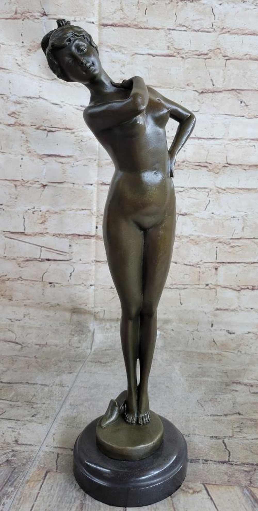 Playful Allure" Bronze Sculpture by Jean Patoue - 17" x 5: "Playful Allure" Bronze Sculpture by Jean Patoue - 17" x 5" This captivating bronze sculpture of a nude woman balances gracefully on her tiptoes, exuding confidence and feminine charm.