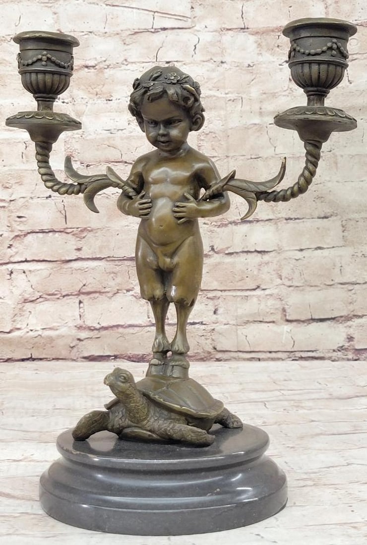 Baby Satyr Candelabrum Bronze Sculpture by Aldo Vitaleh - 13" x 9": Baby Satyr Candelabrum Bronze Sculpture by Aldo Vitaleh - 13" x 9" Introducing a whimsical bronze sculpture of a baby satyr, artfully designed to hold a charming candelabrum. With his hoofs gr