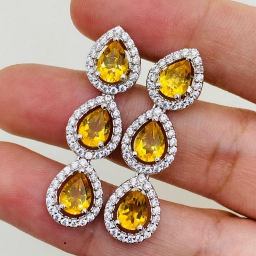 Zirconia Encircled Citrine Earrings: Zirconia Encircled Citrine Earrings These earrings feature 3 Citrine stones on each earring, each encircled by zirconias. View Photos For Further Details.