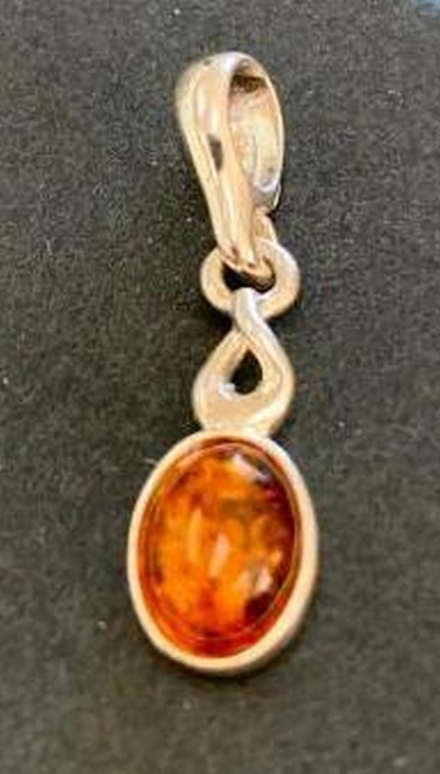 Sterling Silver Amber Pendant with Infinity Twist: Sterling Silver Amber Pendant with Infinity Twist A delicate and meaningful design, this sterling silver pendant features a warm oval amber stone topped with an elegant infinity-style twist. The grac