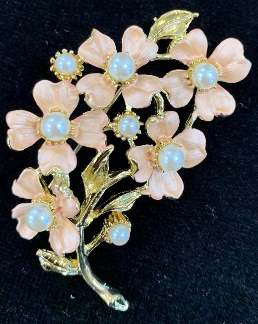 Coral Coloured Floral Brooch with Inlaid White Pearl Accents: Coral Coloured Floral Brooch with Inlaid White Pearl Accents White pearls are thought to symbolize innocence, new beginnings, beauty and sincerity. They have also been said to signify femininity,