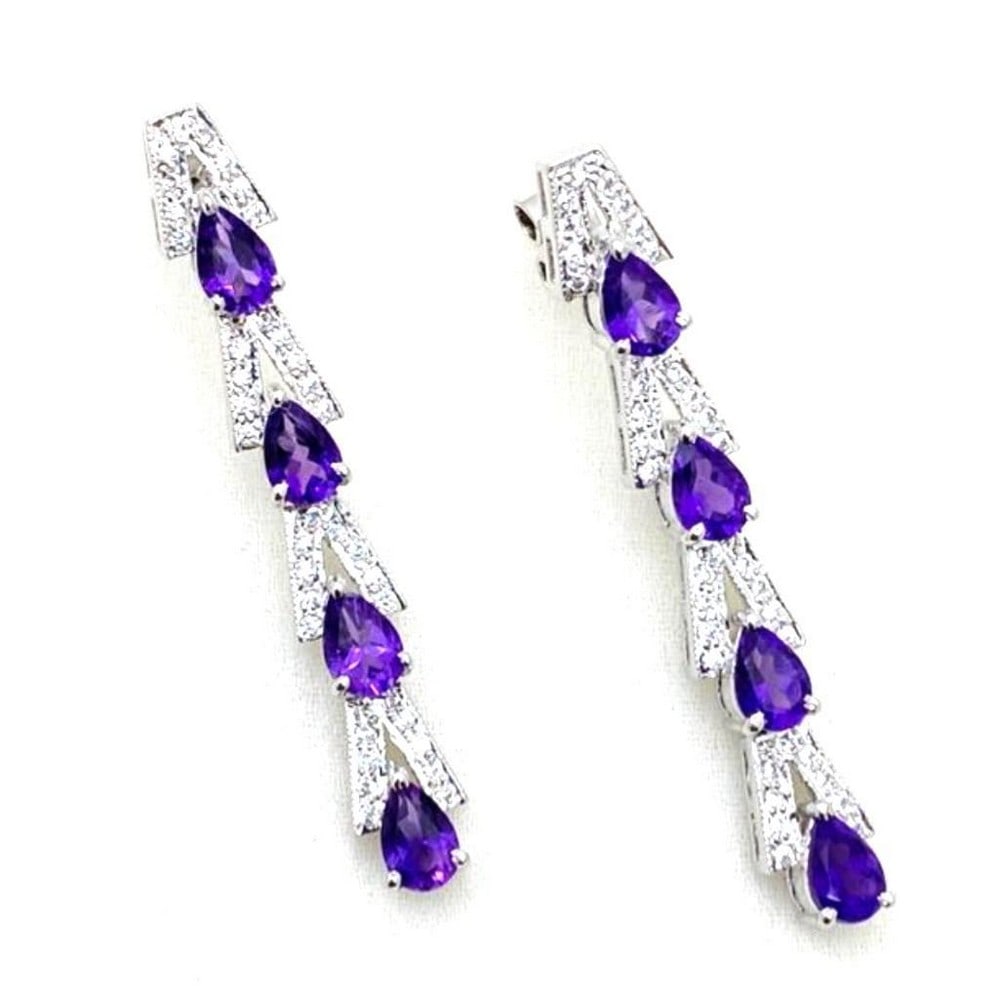 Amethyst and Zirconia Line Dangle Earrings: Amethyst and Zirconia Line Dangle Earrings These earrings feature a pattern of Amethyst and Zirconia. They are stud type earrings and are 925 Sterling Silver. View Photos For Further Details.